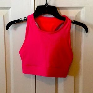 Hot pink sports bra with phone pocket in the back.